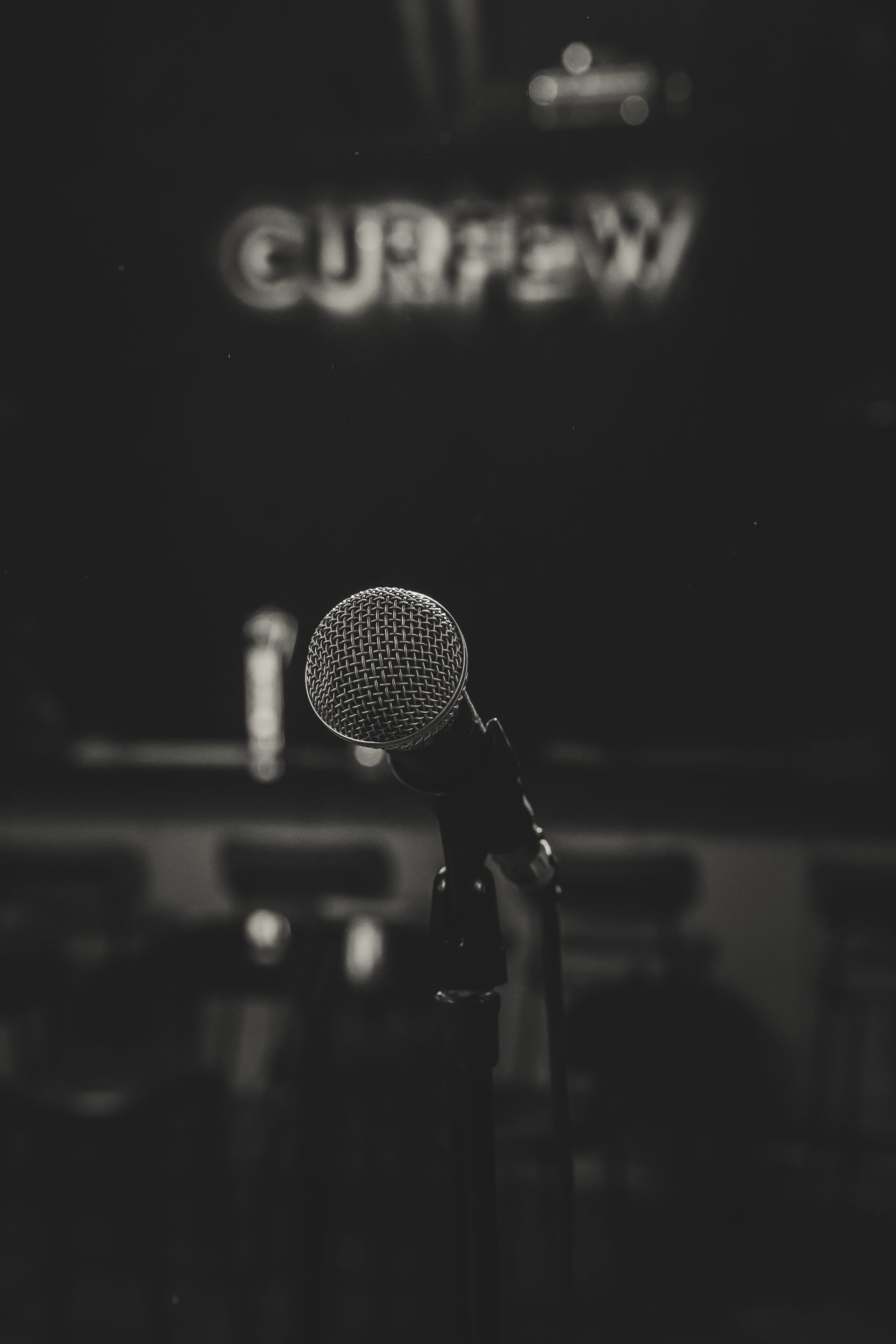A microphone on a dark stage. Stock concept photograph.